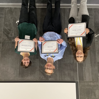 Group of people holding certificates from the 2024 IPS Meeting