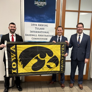 Iowa Law team with Hawkeye flag
