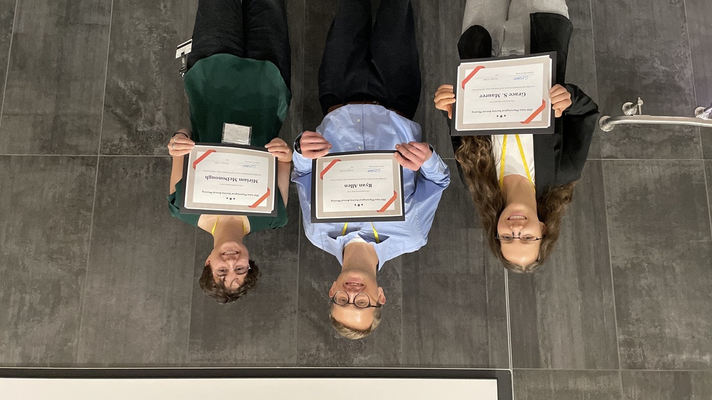 Group of people holding certificates from the 2024 IPS Meeting
