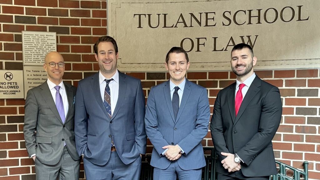 Dan Matheson with students in front of Tulane building