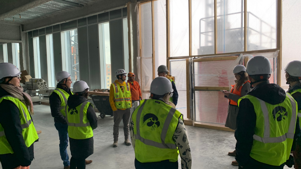 Group touring the interior of Health Sciences Academic Building construction