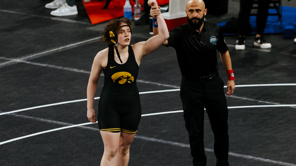 Naomi Simon getting her hand raised following a wrestling match