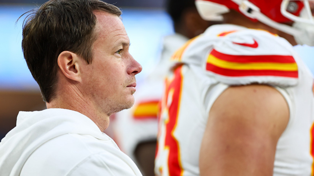 Ryan Reynolds standing on the sideline with Kansas City Chiefs players